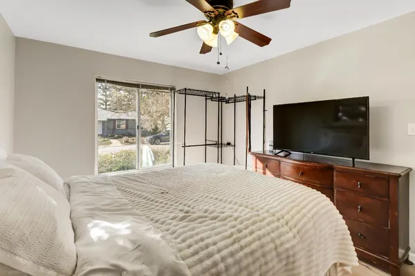 a bedroom with a bed and a flat screen tv