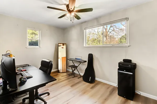 a view of a workspace with furniture and a window