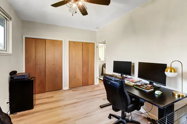 a view of a workspace with furniture and wooden floor