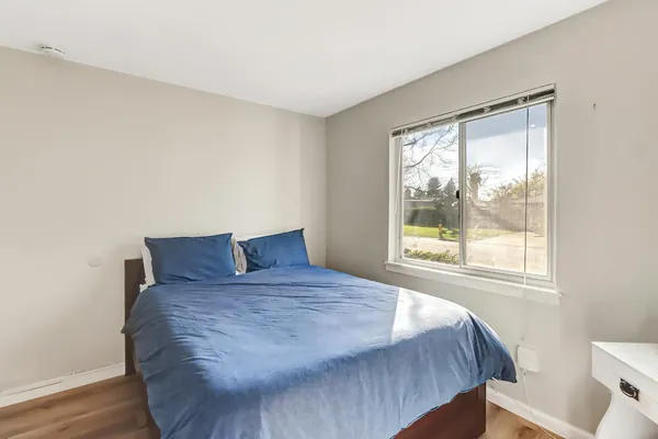 a large bed sitting in a bedroom next to a window