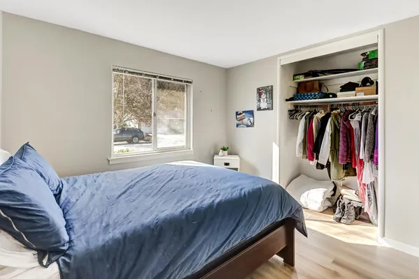 a bed sitting in a bedroom next to a window