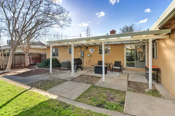 a view of a building with sitting area and garden