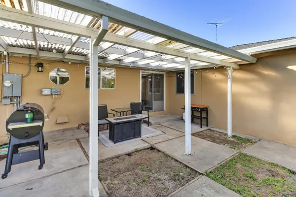 a outdoor space with lots of chairs and a rug