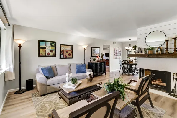 a living room with furniture and a wooden floor