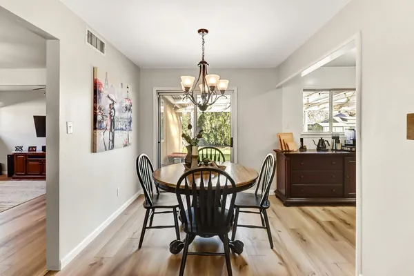 a view of a dining room with furniture window and wooden floor