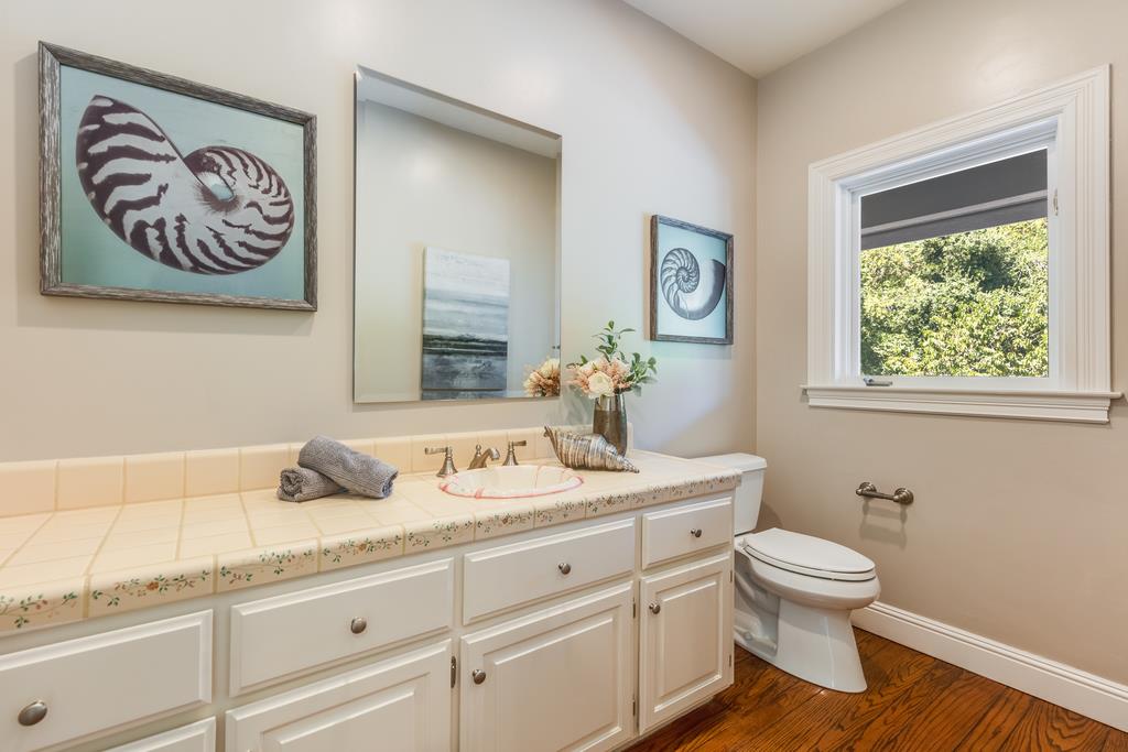 12385 Parker Ranch Road Saratoga, CA 95070 - Photo 16 of 50 a bathroom with a granite countertop toilet sink and mirror