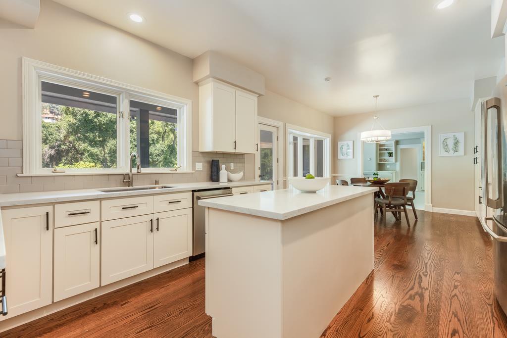 12385 Parker Ranch Road Saratoga, CA 95070 - Photo 17 of 50 a kitchen with white cabinets and sink