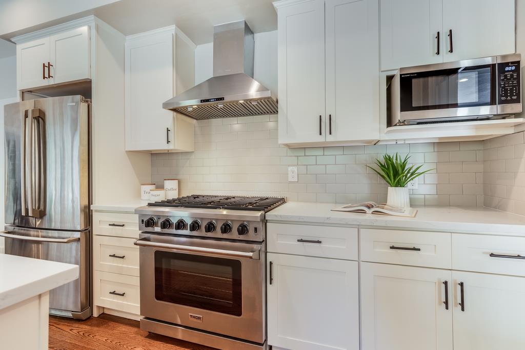 12385 Parker Ranch Road Saratoga, CA 95070 - Photo 21 of 50 a kitchen with stainless steel appliances a stove a microwave and cabinets