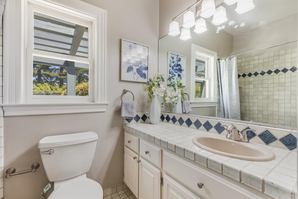 12385 Parker Ranch Road Saratoga, CA 95070 - Photo 36 of 50 a bathroom with a granite countertop toilet a sink and a mirror