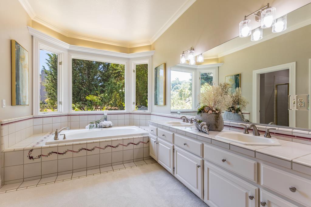 12385 Parker Ranch Road Saratoga, CA 95070 - Photo 45 of 50 a bathroom with double vanity sinks a large mirror and a bathtub next to a window