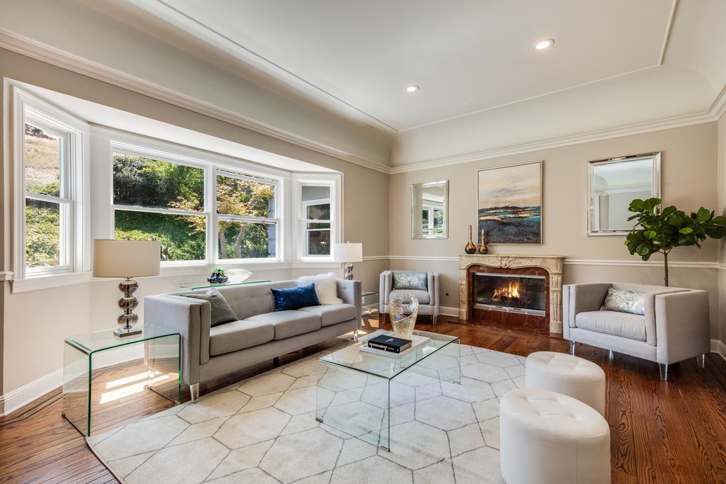 12385 Parker Ranch Road Saratoga, CA 95070 - Photo 10 of 50 a living room with furniture a fireplace and a large window