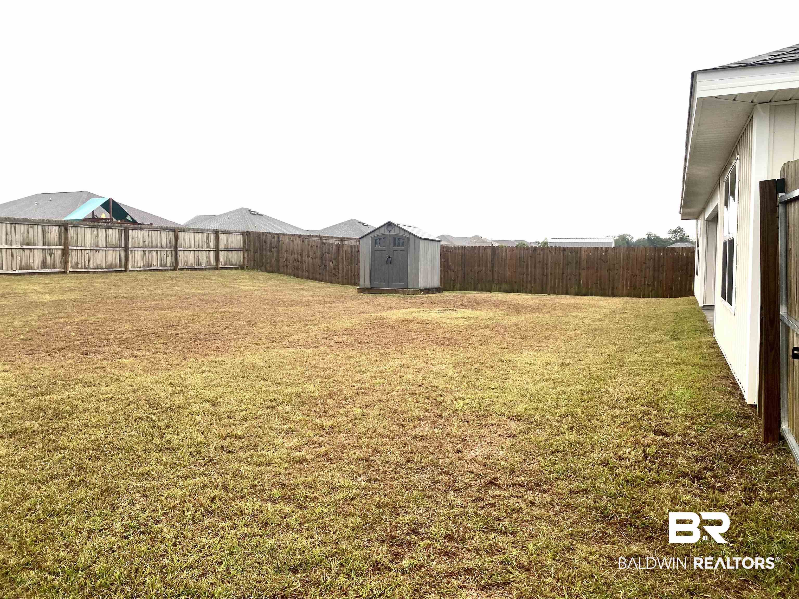 14496 Cavendish Drive Foley, AL 36535 - Photo 26 of 26 Fenced backyard with a shed
