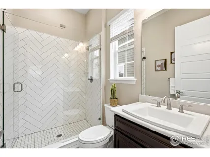 a bathroom with a toilet a sink and a mirror