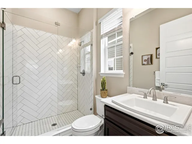 a bathroom with a toilet a sink and a mirror