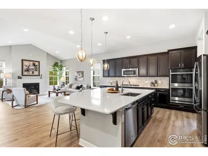 a large kitchen with lots of counter space a sink appliances and dining room