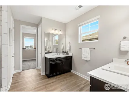 a bathroom with a shower sink and mirror