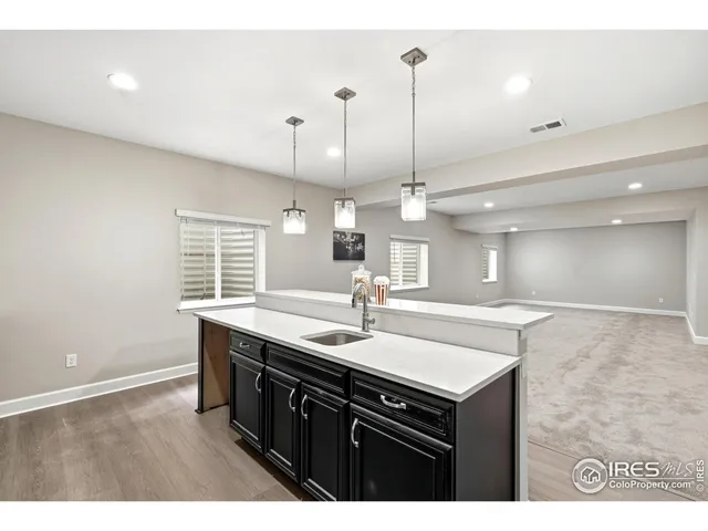 a kitchen with stainless steel appliances sink cabinets and window