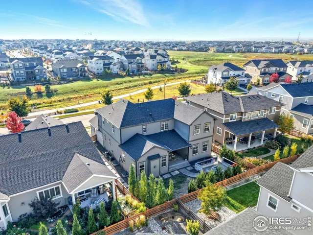 an aerial view of a house with a swimming pool outdoor seating and yard
