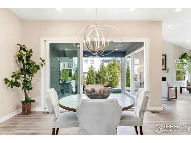 a dining room with furniture a chandelier and wooden floor