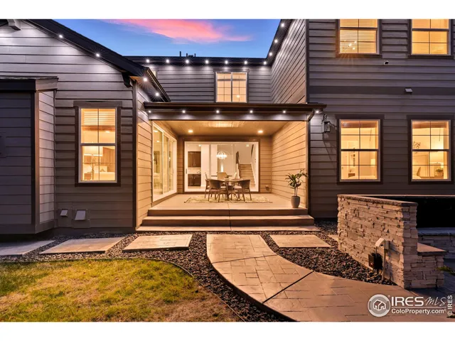 a kitchen with kitchen island a counter space a sink appliances and a wooden floor