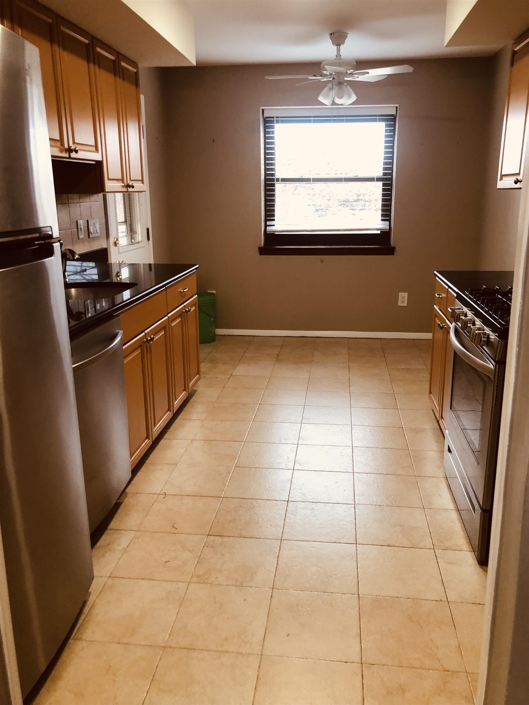 4 Green Valley Court, Unit 4 Secaucus, NJ 07094 - Photo 4 of 10 a kitchen with granite countertop a stove a sink and a refrigerator