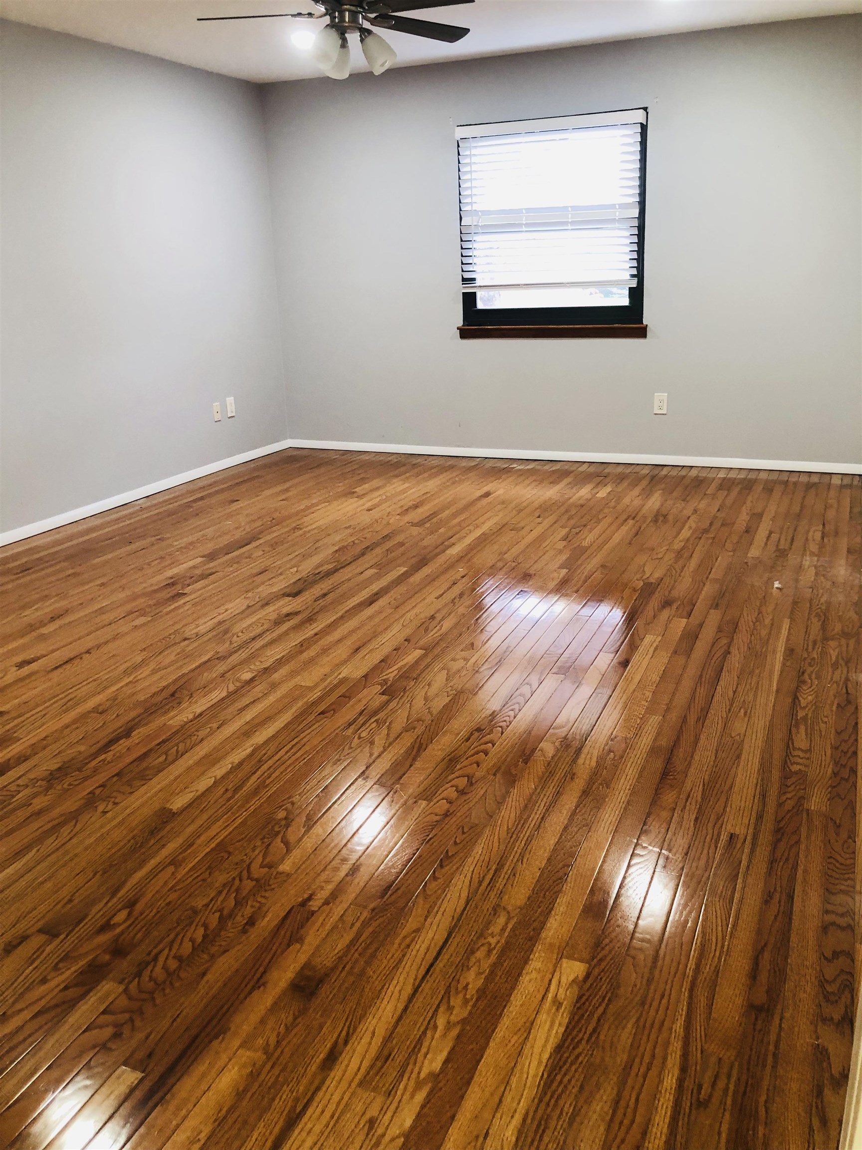 4 Green Valley Court, Unit 4 Secaucus, NJ 07094 - Photo 5 of 10 a view of an empty room with wooden floor and a window