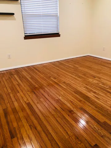 a view of a room with wooden floor and a sink