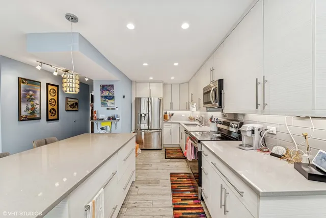 a kitchen with a sink appliances and cabinets