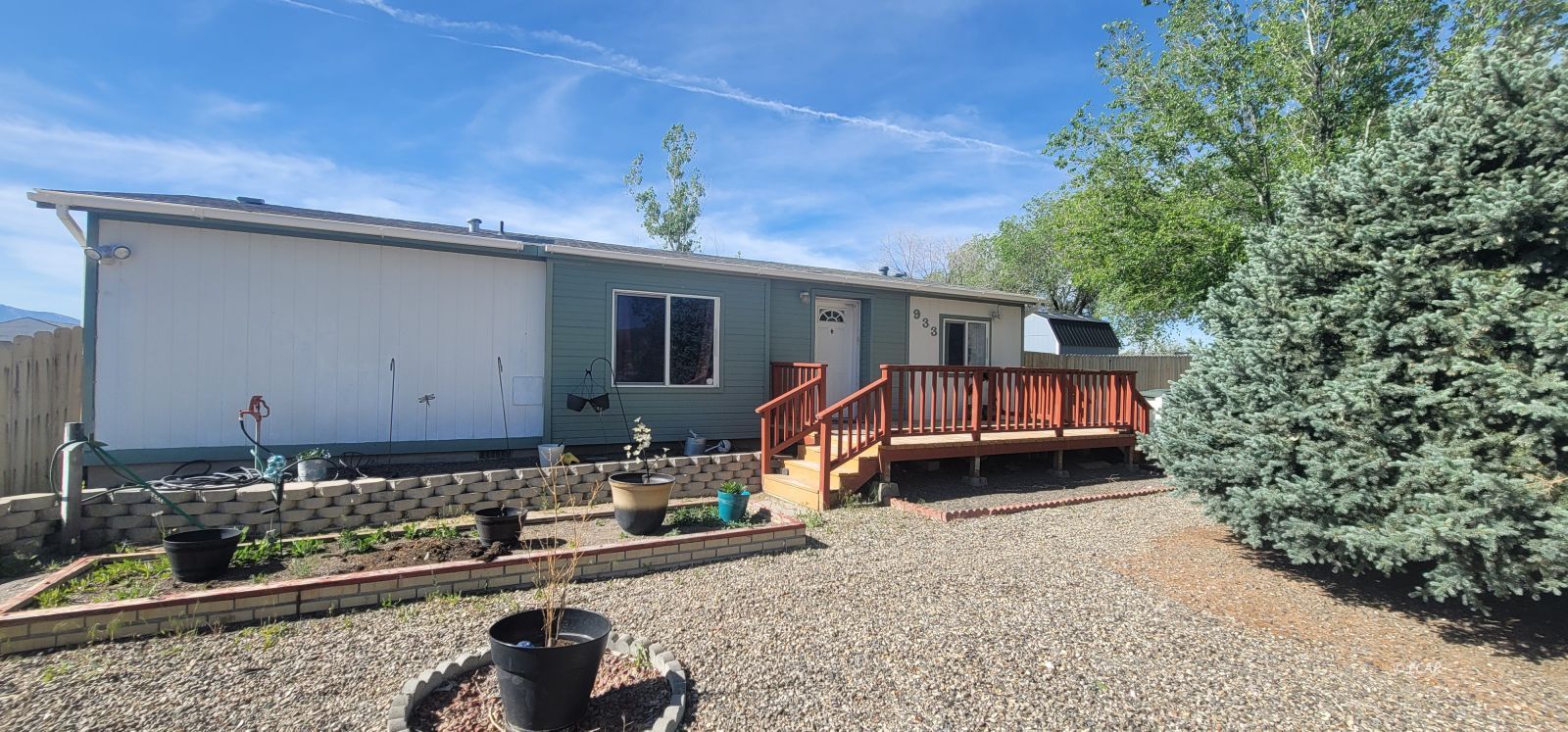 933 Spring Valley Parkway Spring Creek, NV 89815 - Photo 6 of 27 a front view of a house with garden