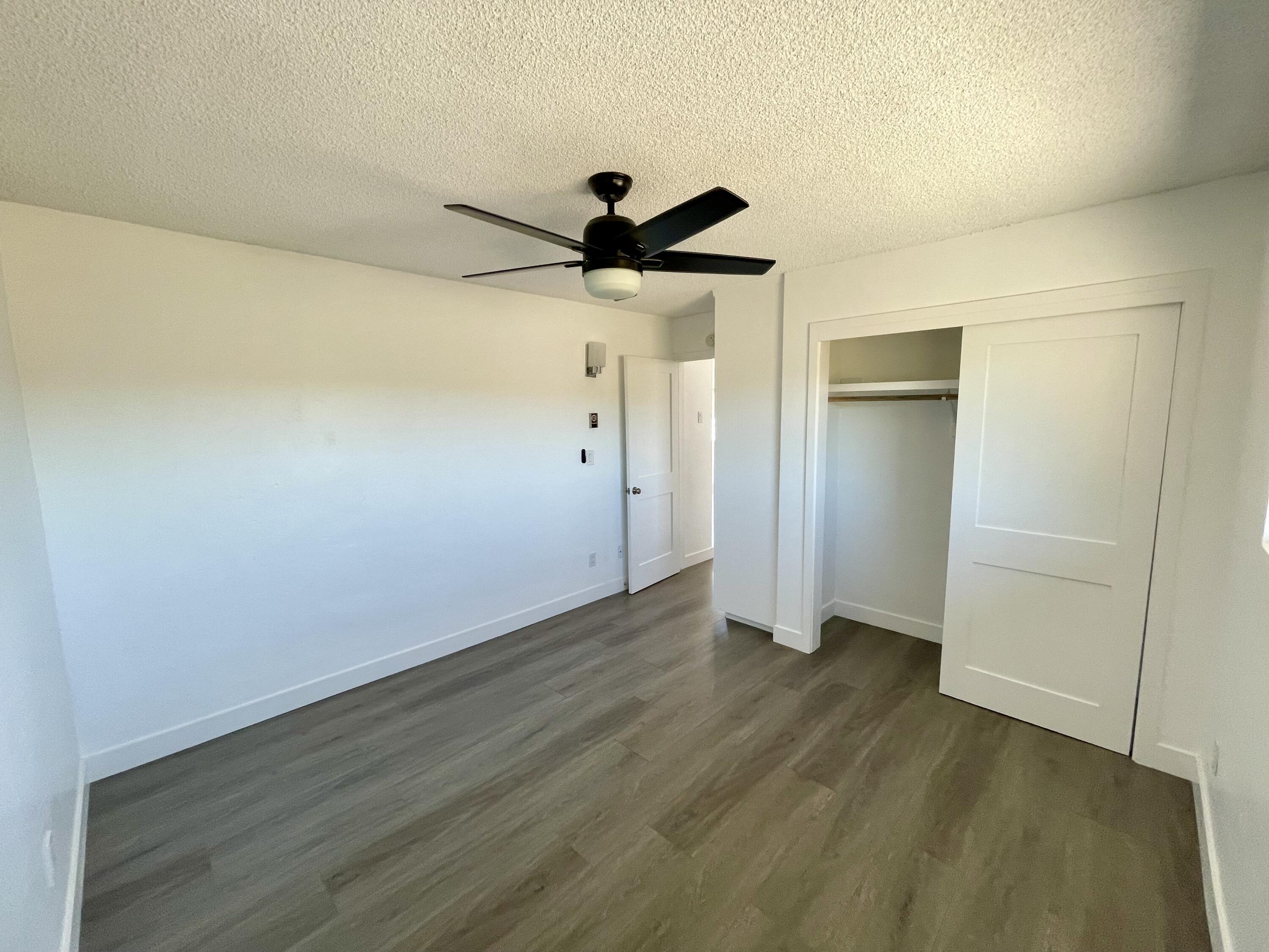 61880 Verbena Road Joshua Tree, CA 92252 - Photo 14 of 20 a view of a room with wooden floor and a ceiling fan