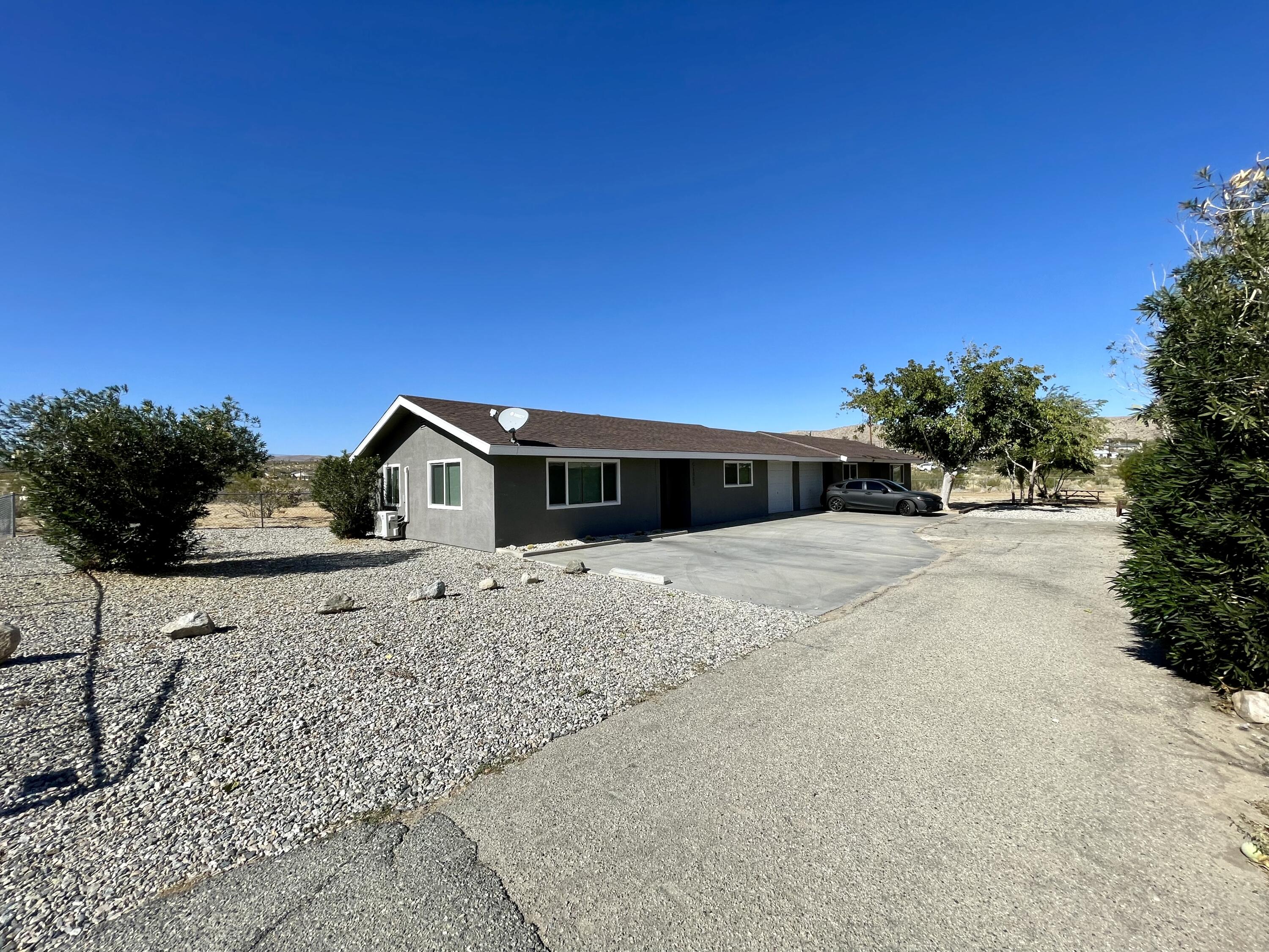 61880 Verbena Road Joshua Tree, CA 92252 - Photo 3 of 20 a front view of a house with a yard