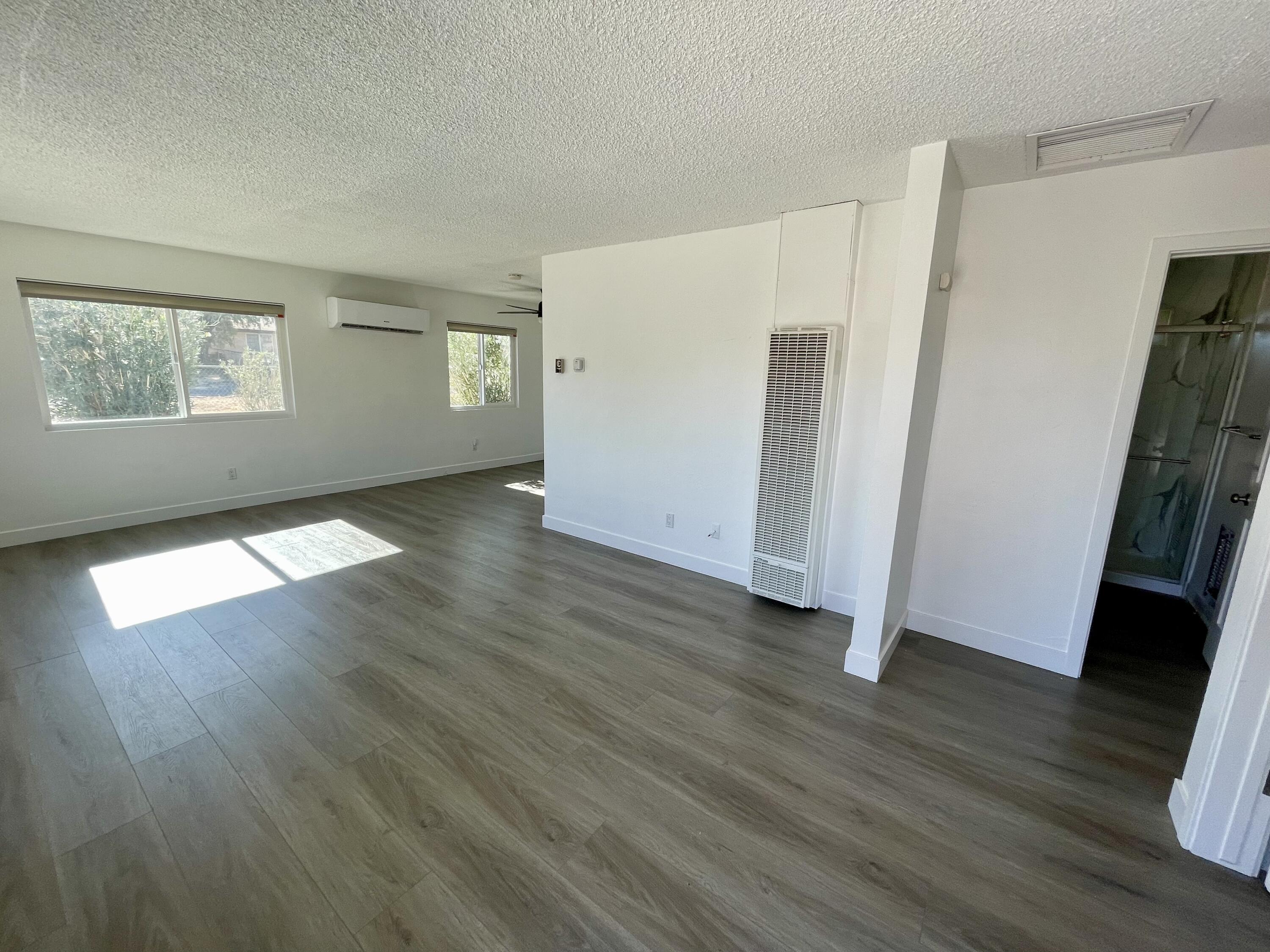 61880 Verbena Road Joshua Tree, CA 92252 - Photo 4 of 20 an empty room with wooden floor and windows