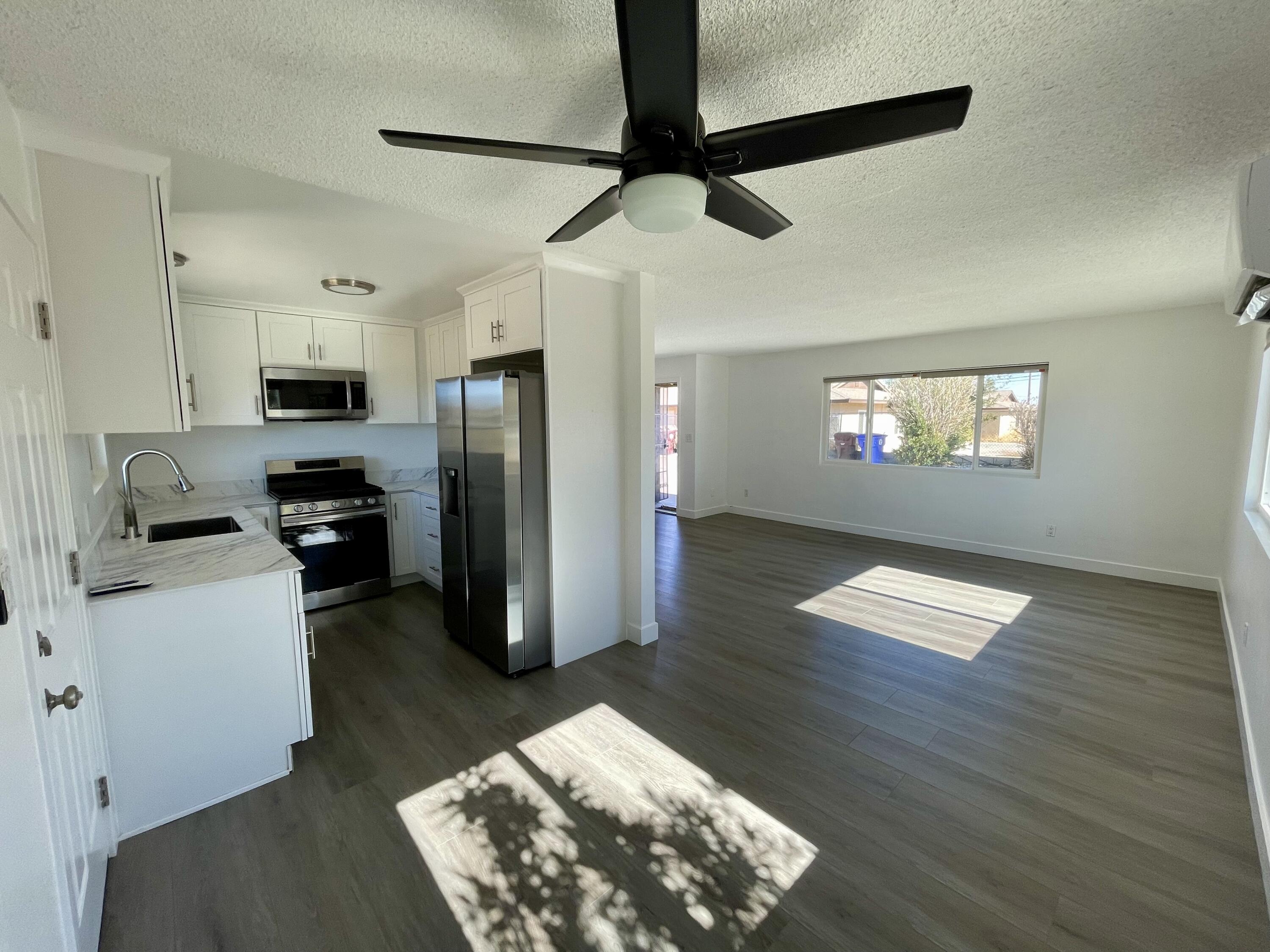 61880 Verbena Road Joshua Tree, CA 92252 - Photo 7 of 20 a kitchen with a refrigerator and a stove top oven