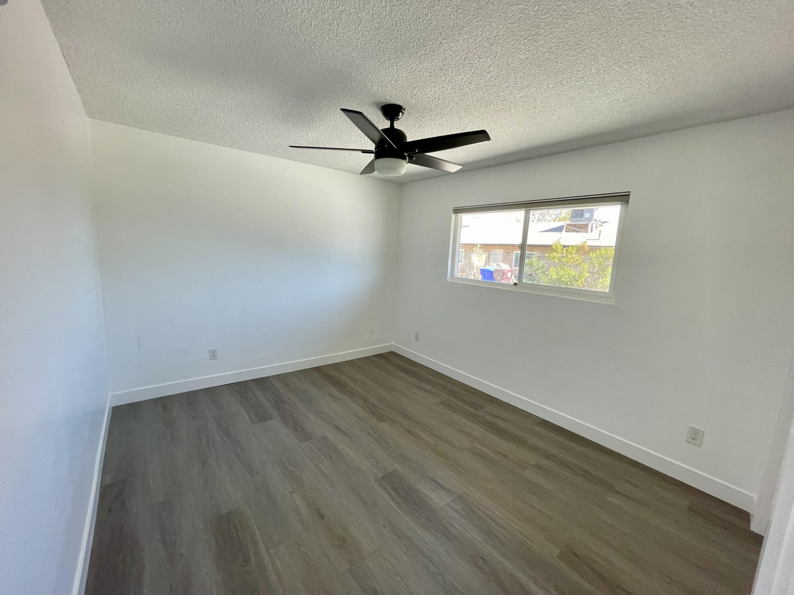 61880 Verbena Road Joshua Tree, CA 92252 - Photo 9 of 20 an empty room with windows and fan
