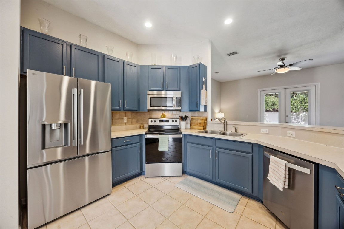 86132 Red Holly Place Yulee, FL 32097 - Photo 16 of 40 a kitchen with granite countertop stainless steel appliances and refrigerator