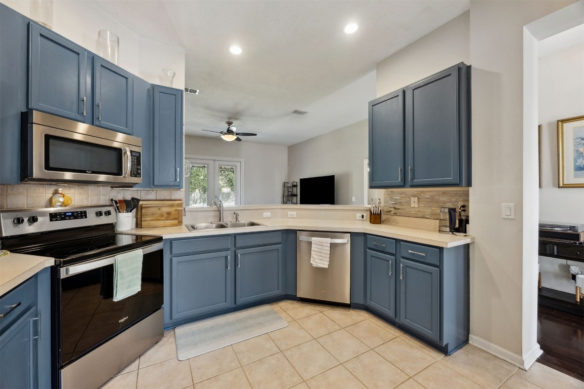 86132 Red Holly Place Yulee, FL 32097 - Photo 17 of 40 a kitchen with a sink stove and microwave