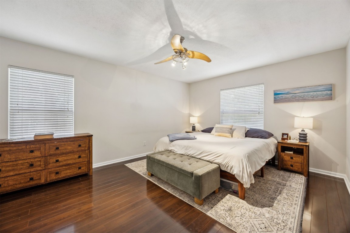 86132 Red Holly Place Yulee, FL 32097 - Photo 19 of 40 a bedroom with a bed and wooden floor