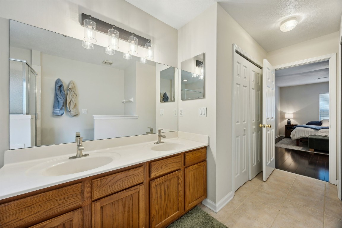 86132 Red Holly Place Yulee, FL 32097 - Photo 23 of 40 a en suite bathroom with double sink and a mirror