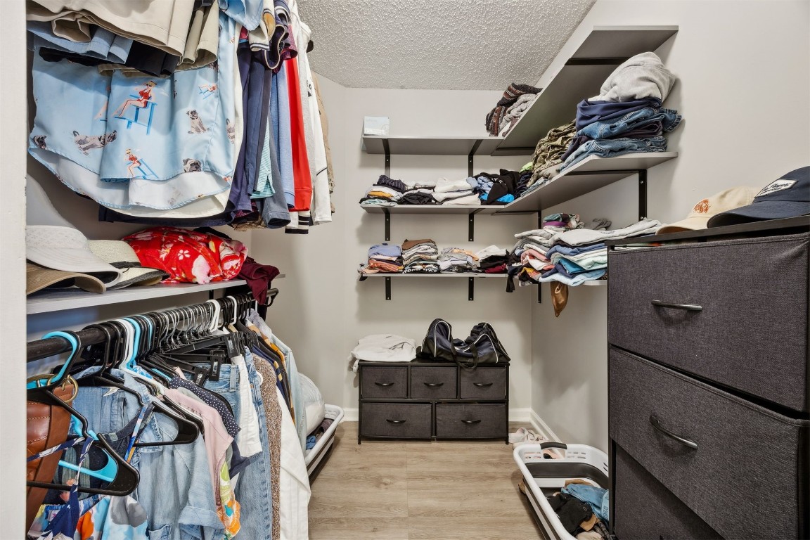 86132 Red Holly Place Yulee, FL 32097 - Photo 24 of 40 a view of walk in closet with clothes and shoes