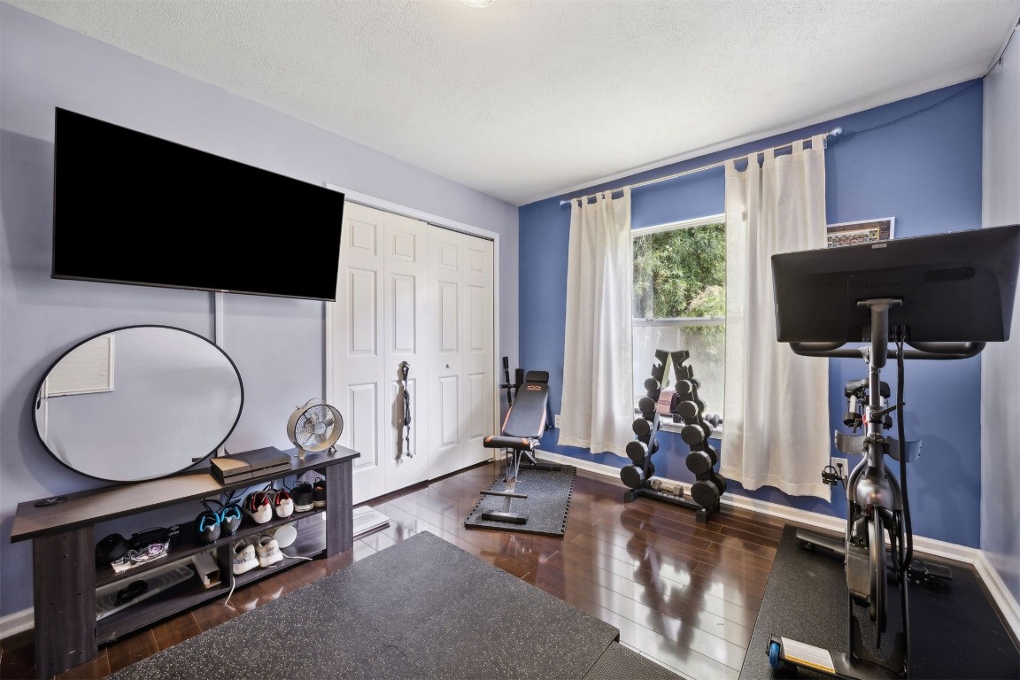 86132 Red Holly Place Yulee, FL 32097 - Photo 25 of 40 a room with gym equipment and a flat screen tv