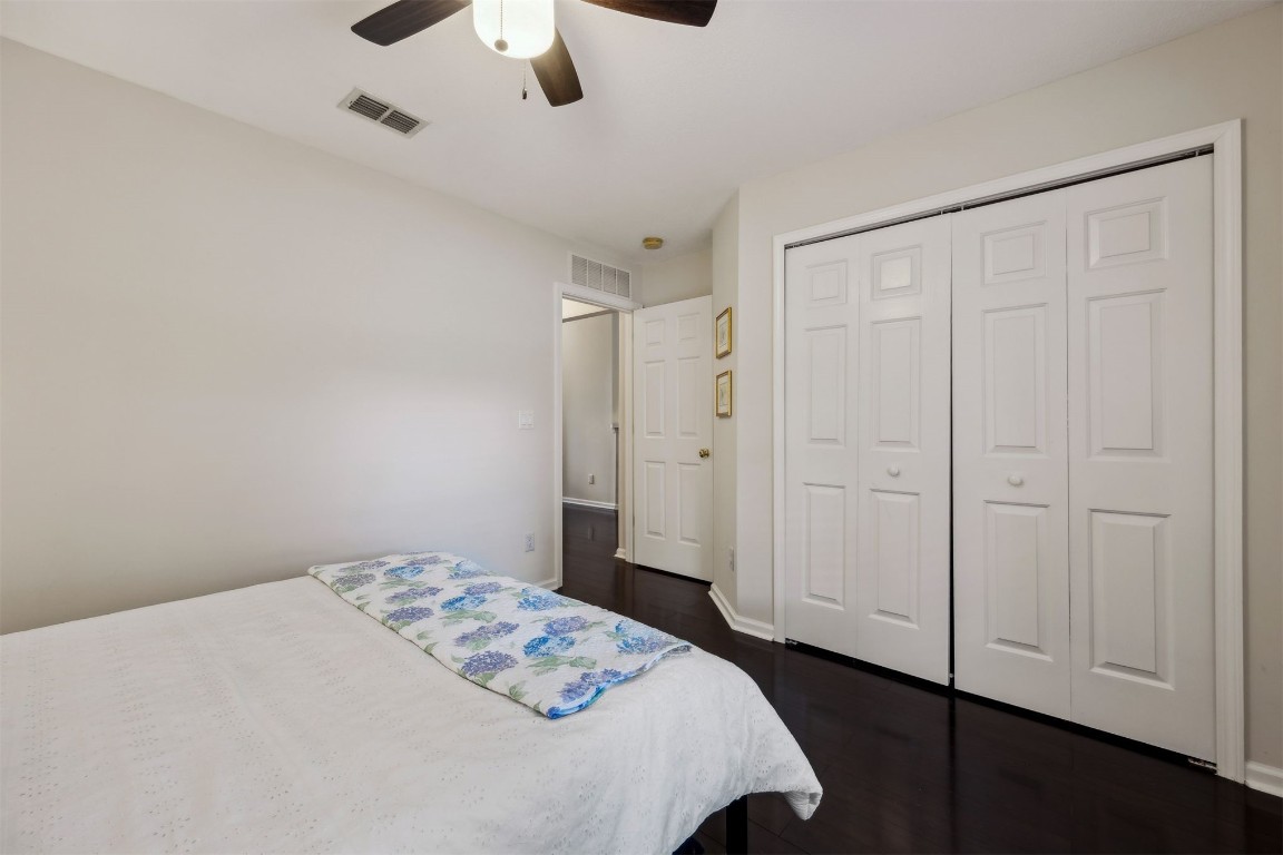 86132 Red Holly Place Yulee, FL 32097 - Photo 29 of 40 a bedroom with a bed and a chandelier fan