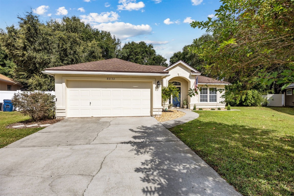 86132 Red Holly Place Yulee, FL 32097 - Photo 38 of 40 a front view of a house with garden