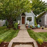 a front view of house with yard and green space