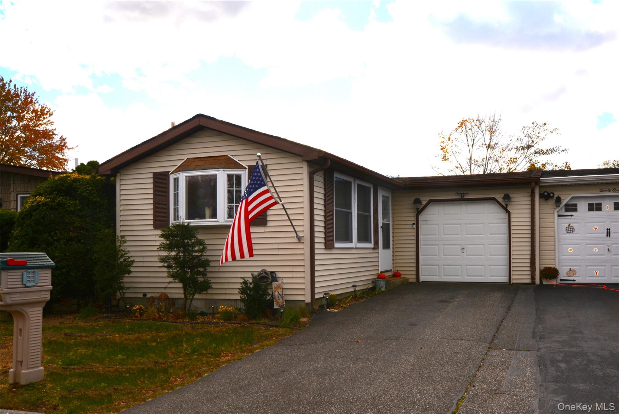 View of front of property with driveway and a garage