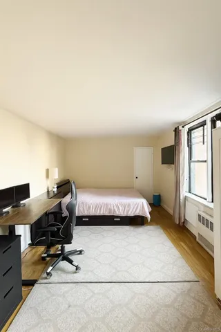 a bedroom with a workspace