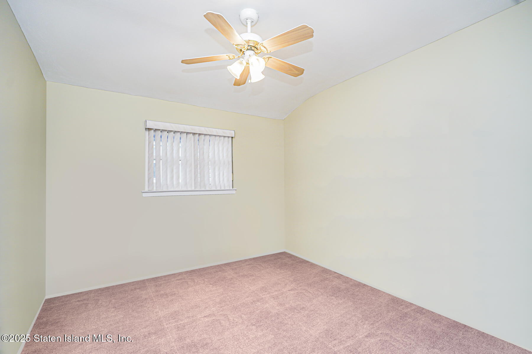 33 Ebey Lane Staten Island, NY 10312 - Photo 16 of 23 an empty room with a chandelier fan and windows
