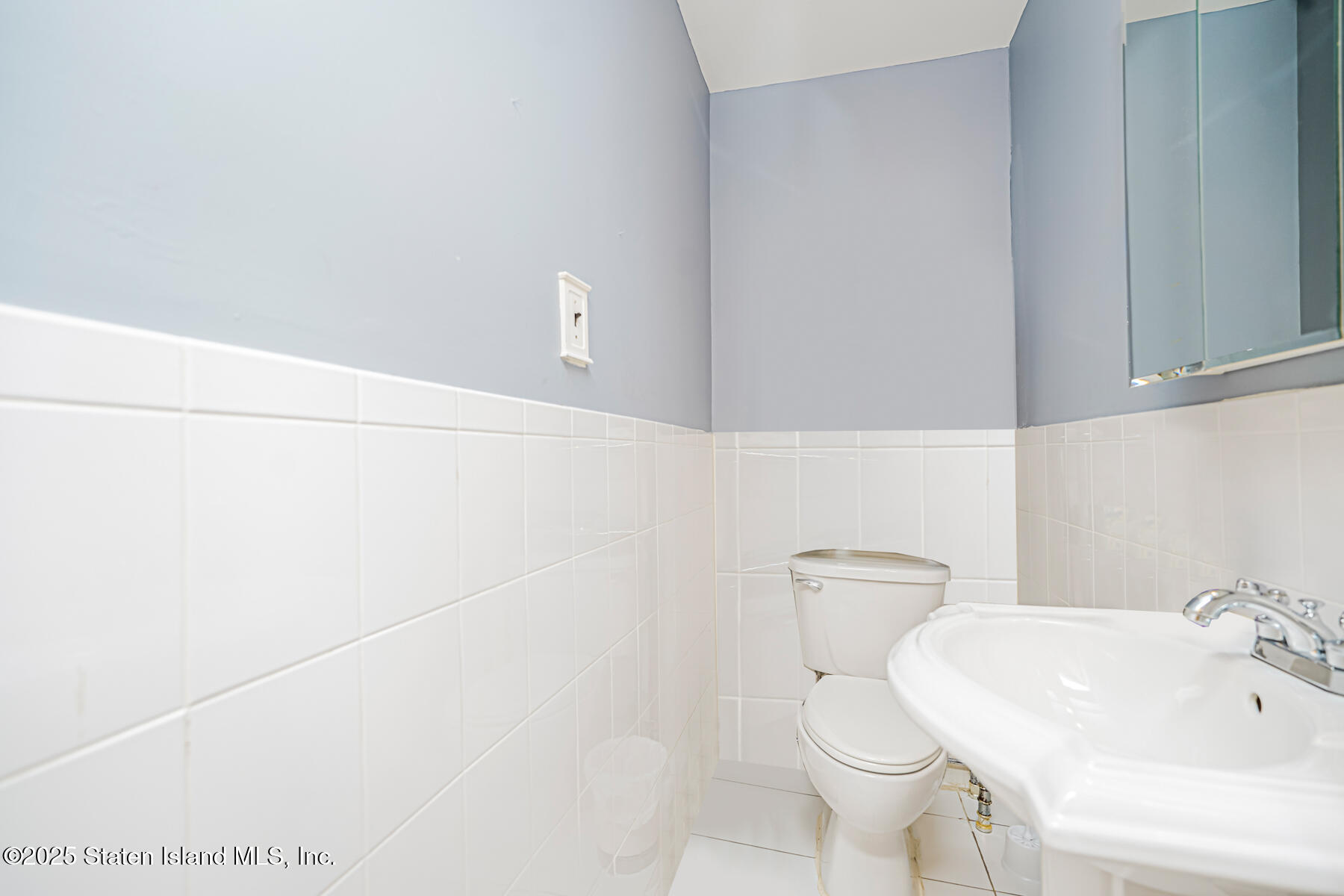 33 Ebey Lane Staten Island, NY 10312 - Photo 10 of 23 a white toilet sitting next to a bathroom sink
