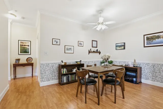 a view of a dining room with furniture and wooden floor