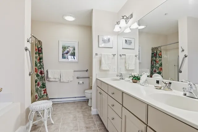 a spacious bathroom with a double vanity sink mirror and toilet