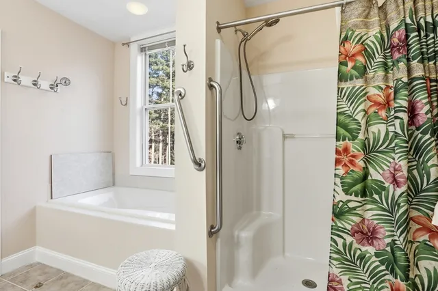 a bathroom with a shower and a shower curtain